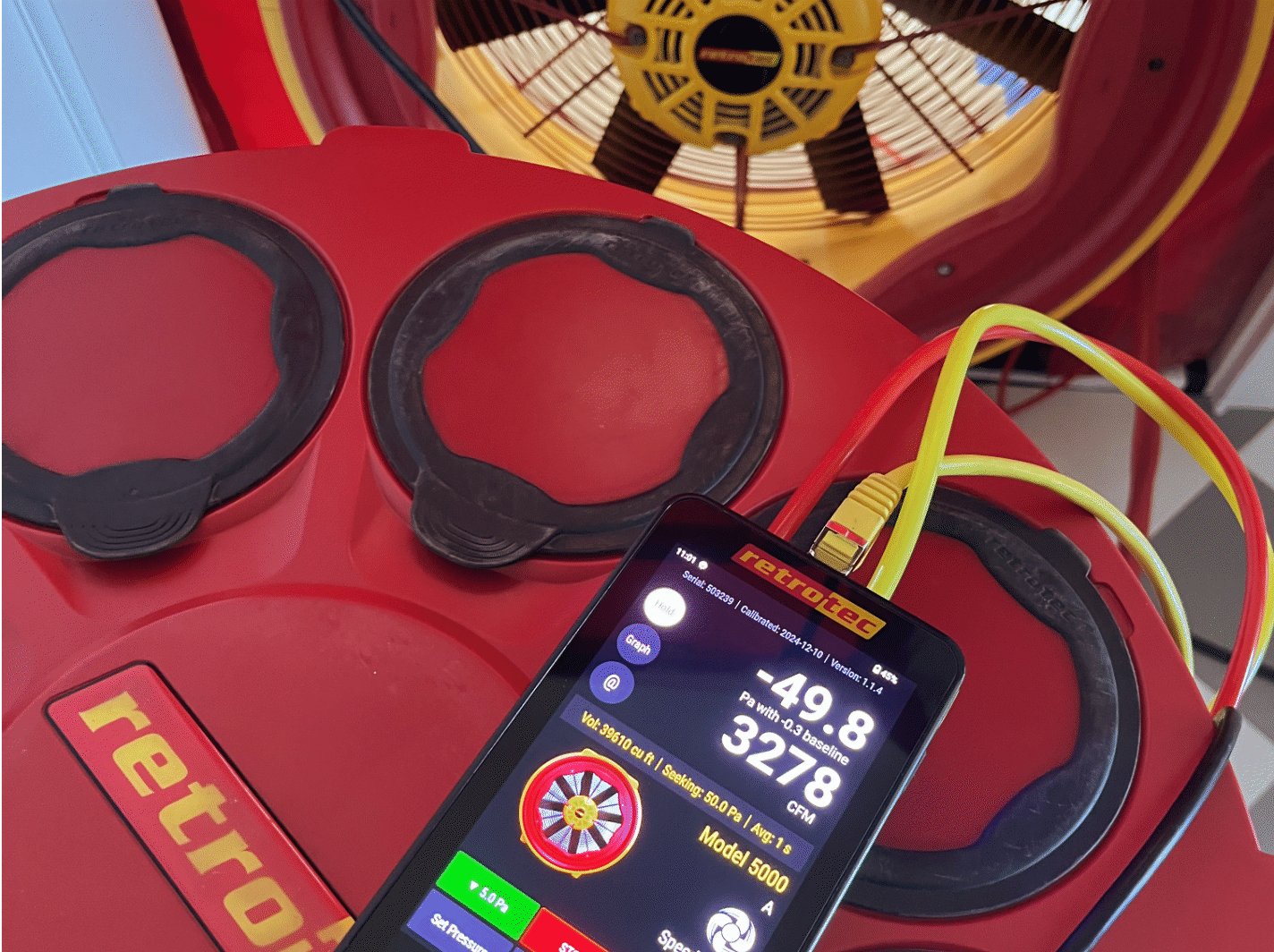 BPI technician performing blower door test on new construction home in Seattle